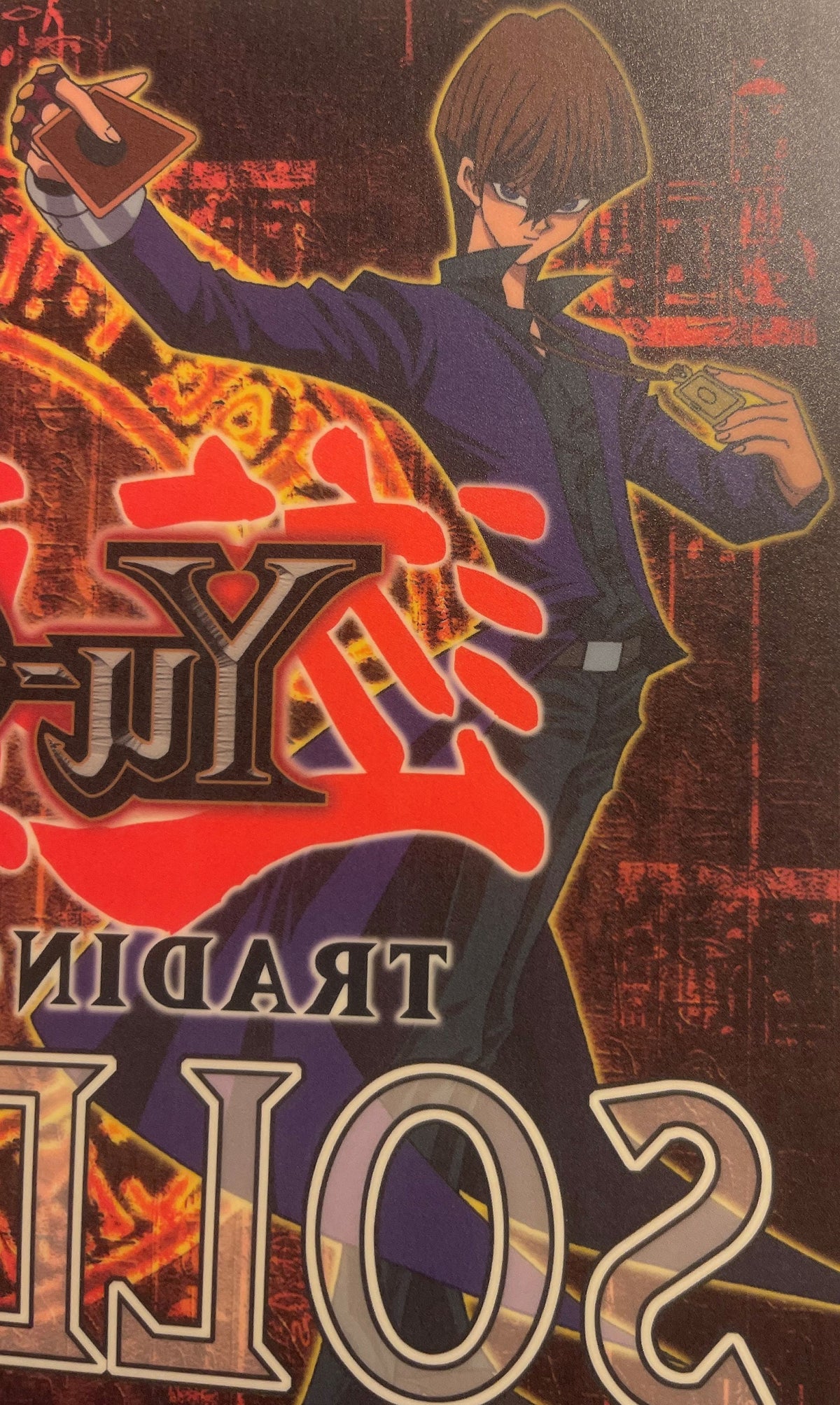 Retro Yu-Gi-Oh! window cling featuring anime character in blue jacket holding trading cards against red and gold