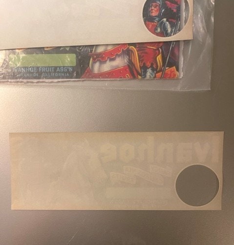 Two vintage fruit crate labels displayed on white background; upper label shows knight in red armor, lower label is blank cre