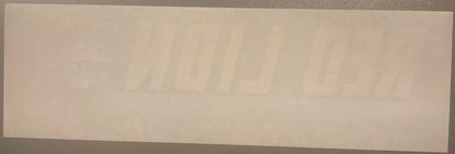 Cream-colored vintage crate label with faint printed text, photographed flat against gray surface