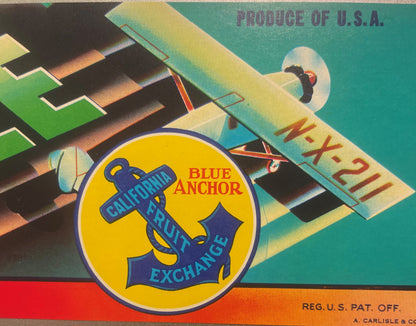 Vintage fruit crate label featuring a blue anchor emblem with "Blue Anchor California Fruit Exchange" text, airplane illustra