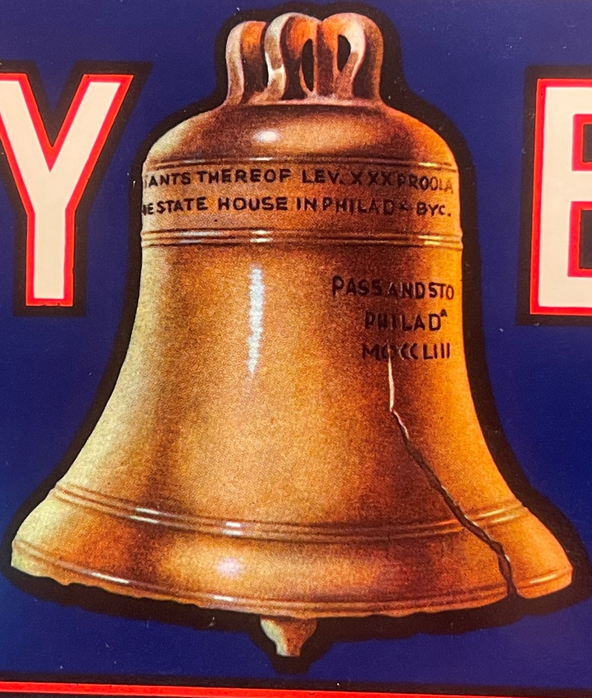 Vintage Liberty Bell crate label featuring a large bronze bell on dark blue background with red text borders and embossed tex