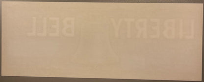 Faded vintage Liberty Bell Brand crate label with embossed text, cream-colored paper on gray background