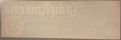 Faded vintage crate label with embossed text and circular design, cream-colored paper with age spots and wear