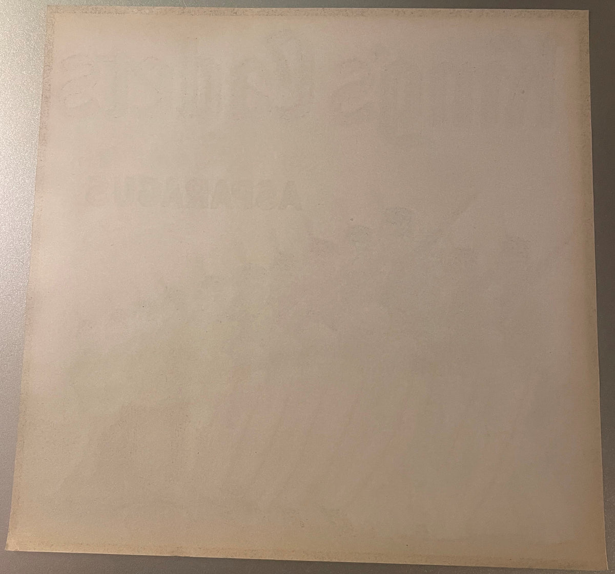 Back of the King's Cadets asparagus label, blank paper with the front printing faintly showing through in reverse