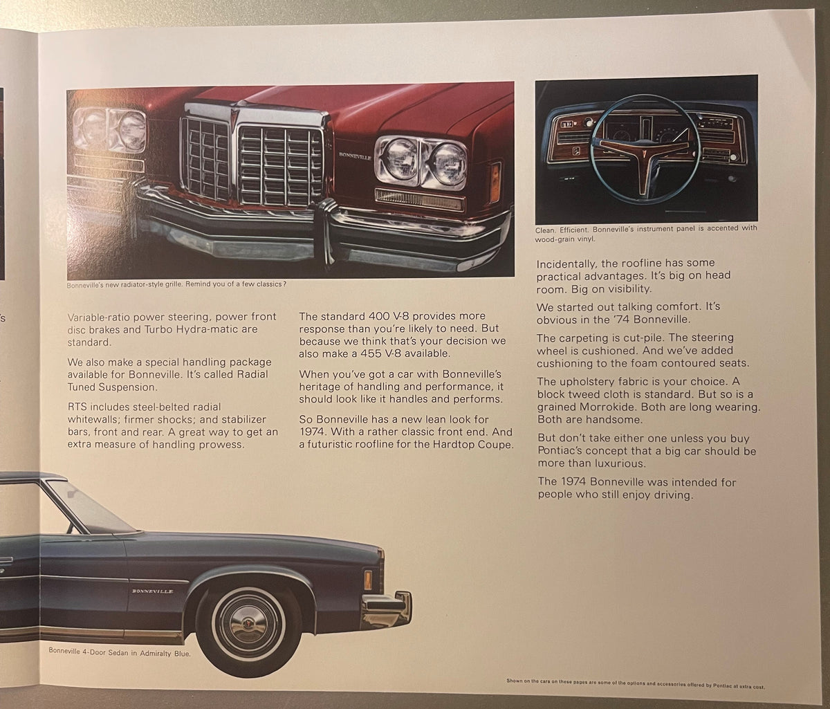 1974 Pontiac Bonneville dealer brochure spread showing front grille, instrument panel with wood-grain vinyl, steering wheel, and side profile of blue sedan with technical specifications and luxury features text.