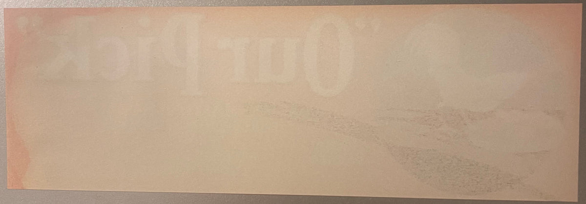 Our Pick crate label, reverse: the blank back of the label in peach and cream stock, with the Our Pick lettering from the front showing through the paper in mirror image
