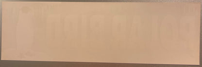 Blank peach-colored vintage fruit crate label with dark border, photographed flat against gray surface