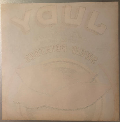 Embossed vintage crate label with "Judy" at top and "Porto Rican" text visible, cream-colored paper with faint circular desig
