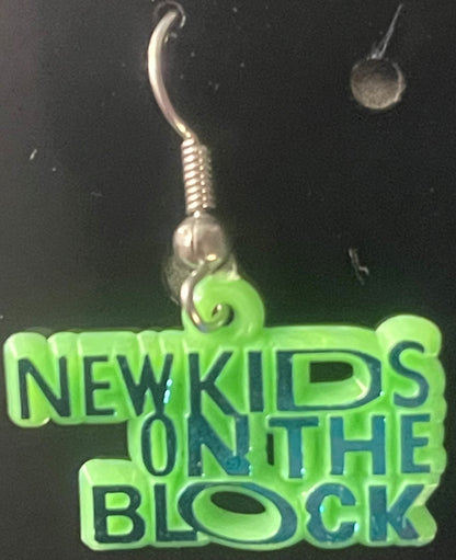 Neon green NKOTB earring charm with silver hook and coiled stem, displayed on matching green text card against dark backgroun