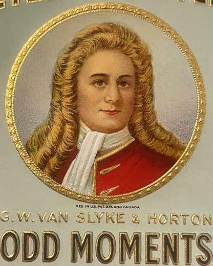 Embossed cigar box label featuring a man in 18th-century dress with long curled hair and red coat, gold decorative border