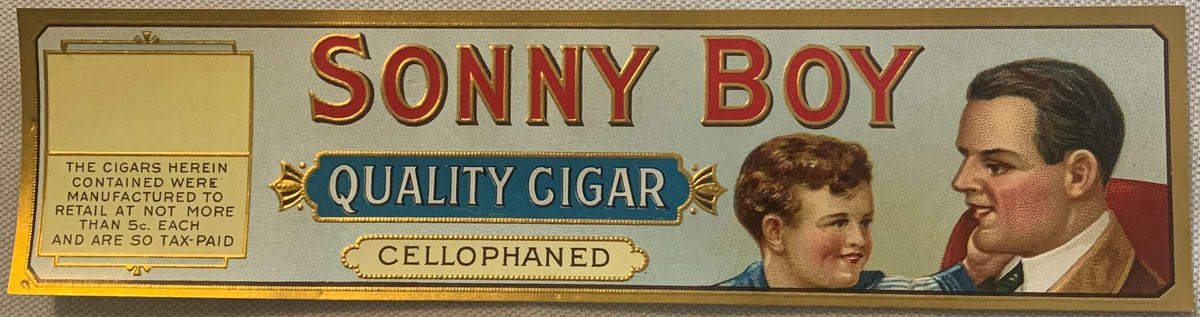 Vintage Sonny Boy Quality Cigar cigar box label showing two men's portraits and embossed cellophane text on cream background.