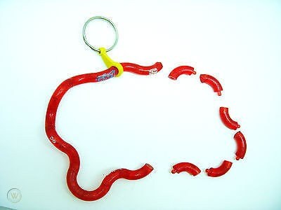 Red segmented tangle toy with metal keyring loop and yellow connector, displayed flat on light blue background