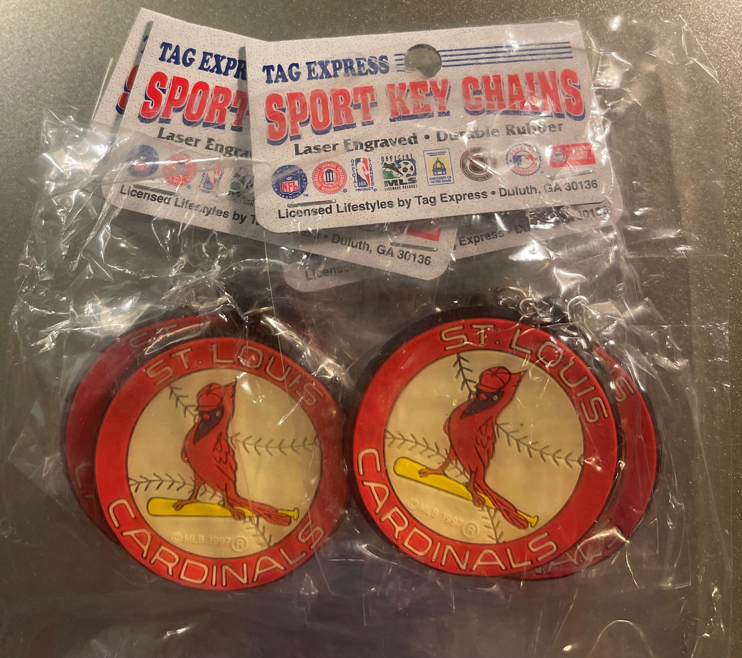 Two red circular St. Louis Cardinals keychains with cardinal bird logo in plastic package with Tag Express Sport Key Chains l