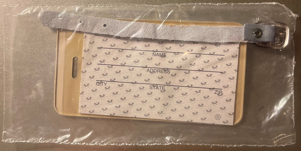 Vintage Mickey Mouse luggage label in plastic packaging with tan and gray colors, printed with fields for name, address, city