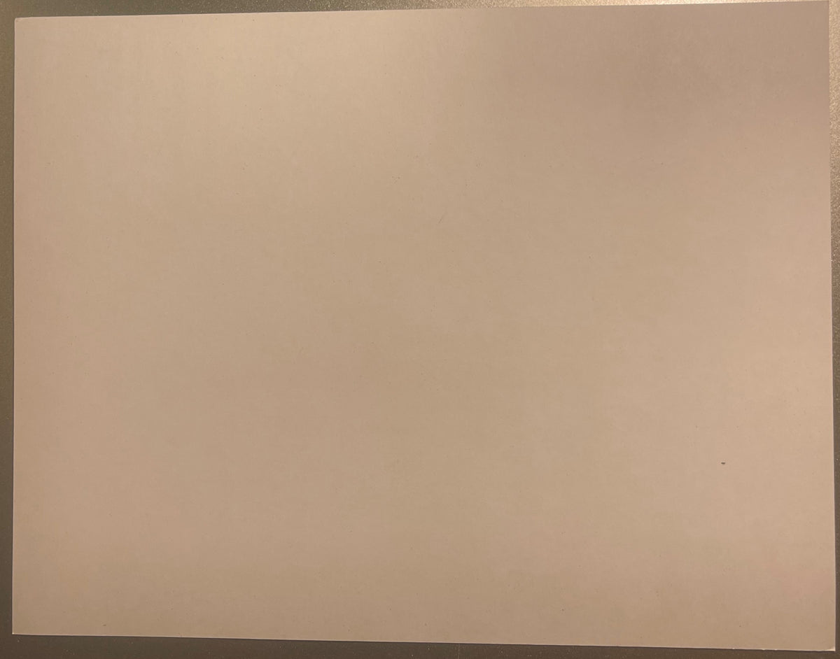 Blank beige rectangular card or cling material photographed flat against a gray background