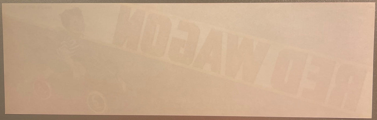 Faded vintage fruit crate label with embossed text on cream-colored paper, details barely visible against light background