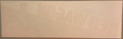 Faded vintage fruit crate label with embossed text on cream-colored paper, details barely visible against light background