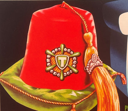 Vintage red fez with gold shield emblem and "T" monogram, green trim band, orange tassel, against dark background.