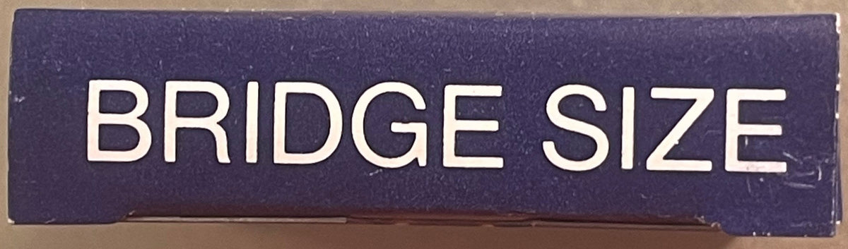 Close-up of navy blue box lid with white sans-serif text reading "BRIDGE SIZE" against tan background surface