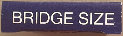 Close-up of navy blue box lid with white sans-serif text reading "BRIDGE SIZE" against tan background surface