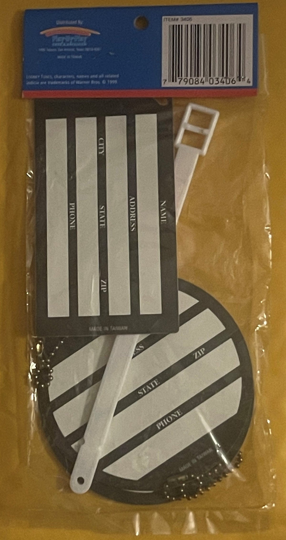 Packaged vintage Looney Tunes key chains and luggage tags with white straps and black circular tag, displayed flat in clear p