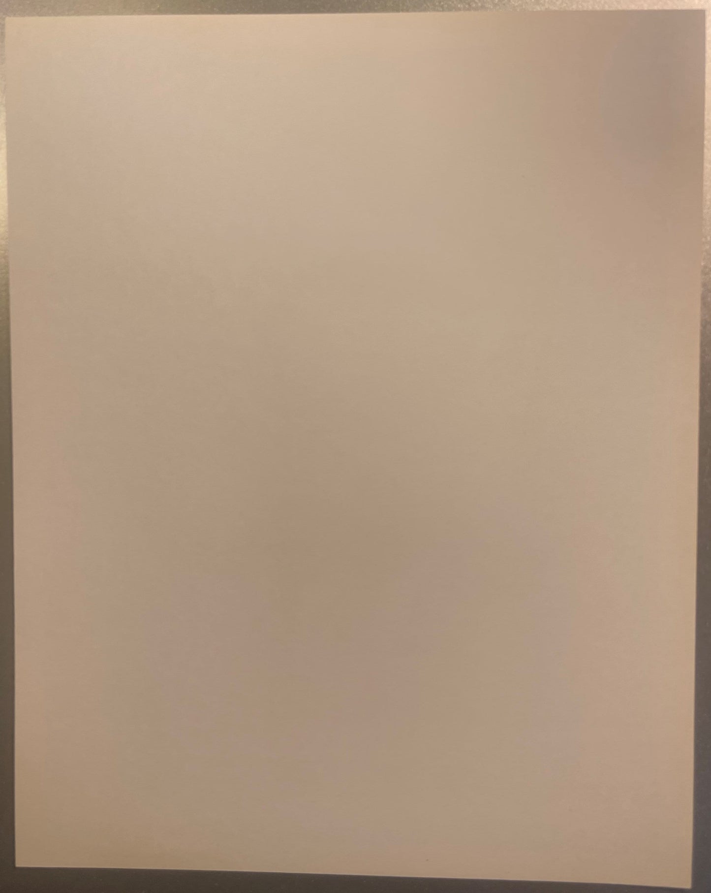 Blank cream-colored page or print backing, photographed flat against a neutral background