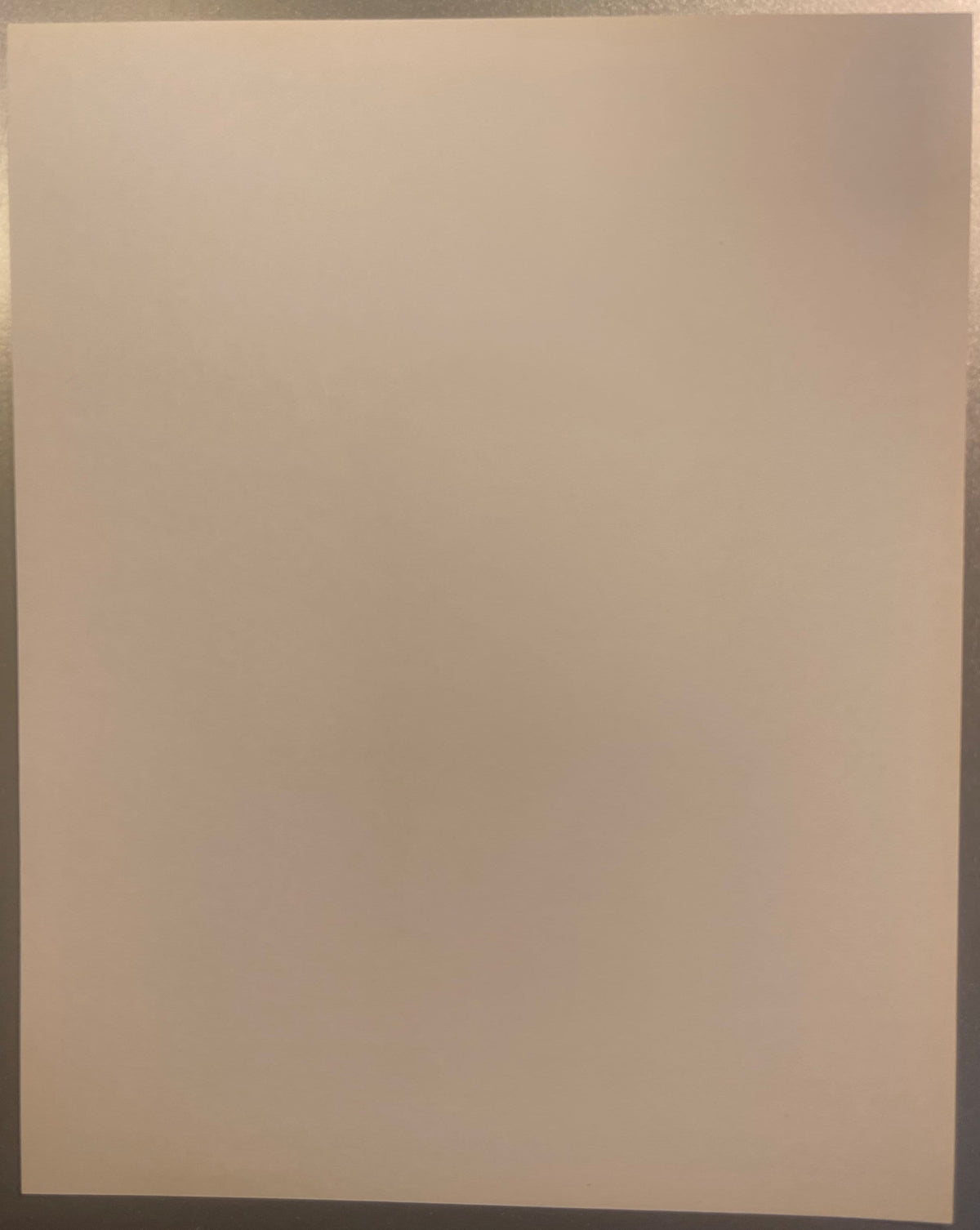 Blank cream-colored page or print backing, photographed flat against a neutral background