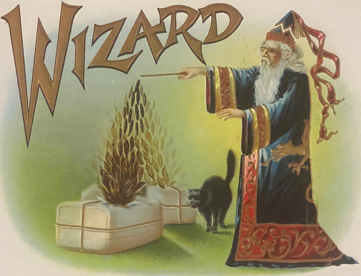 Vintage "Wizard" gold-embossed cigar label featuring a bearded wizard in blue robes pointing at a black cat beside a flaming 