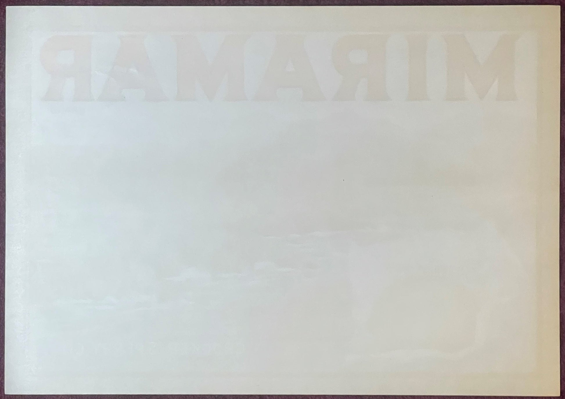 Faded vintage Miramar Sunkist lemon crate label showing watermarked text on cream-colored paper, photographed flat against ne