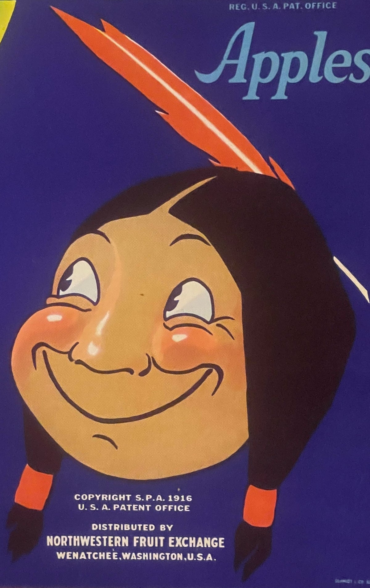 Vintage apple crate label featuring a smiling character with dark hair and orange cheeks wearing a feathered headdress agains