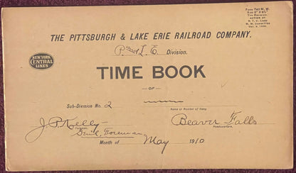 Aged cream-colored 1910 Pittsburgh & Lake Erie Railroad time book cover with handwritten entries for Beaver Falls