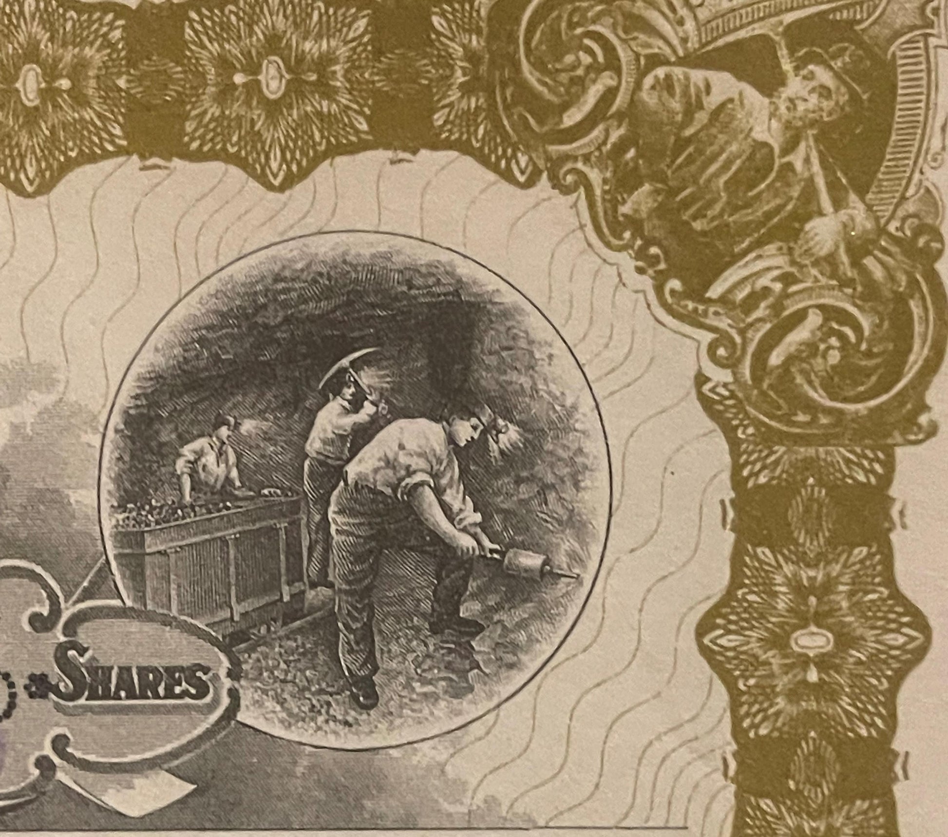 Close-up of antique stock certificate showing engraved vignette of miners working underground, ornate gold border design, and