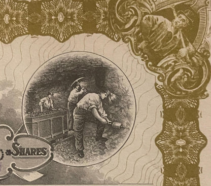 Close-up of antique stock certificate showing engraved vignette of miners working underground, ornate gold border design, and