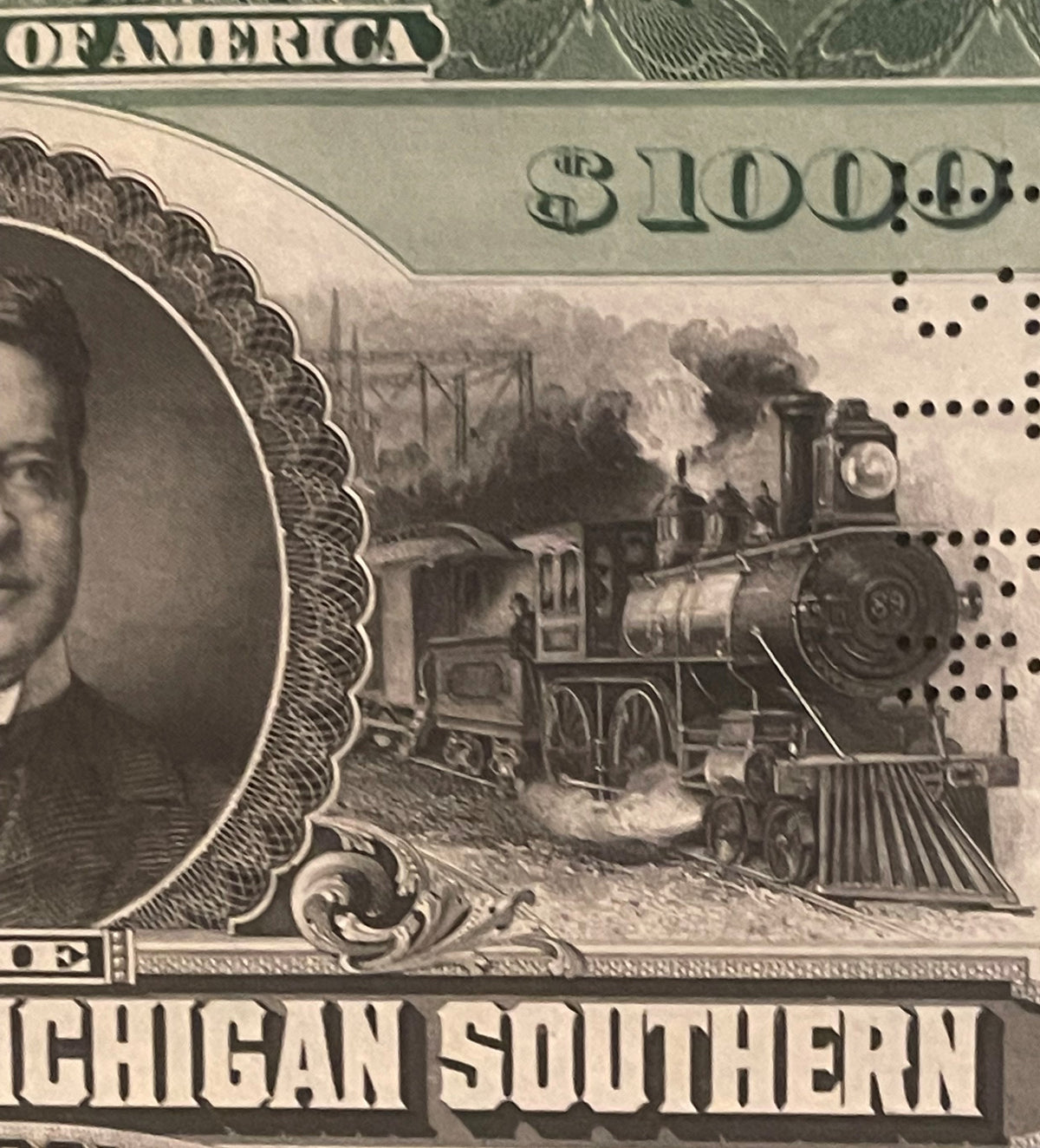 Close-up of 1897 Lake Shore and Michigan Southern bond showing steam locomotive vignette, "$1100" denomination, and "CHIGAN S