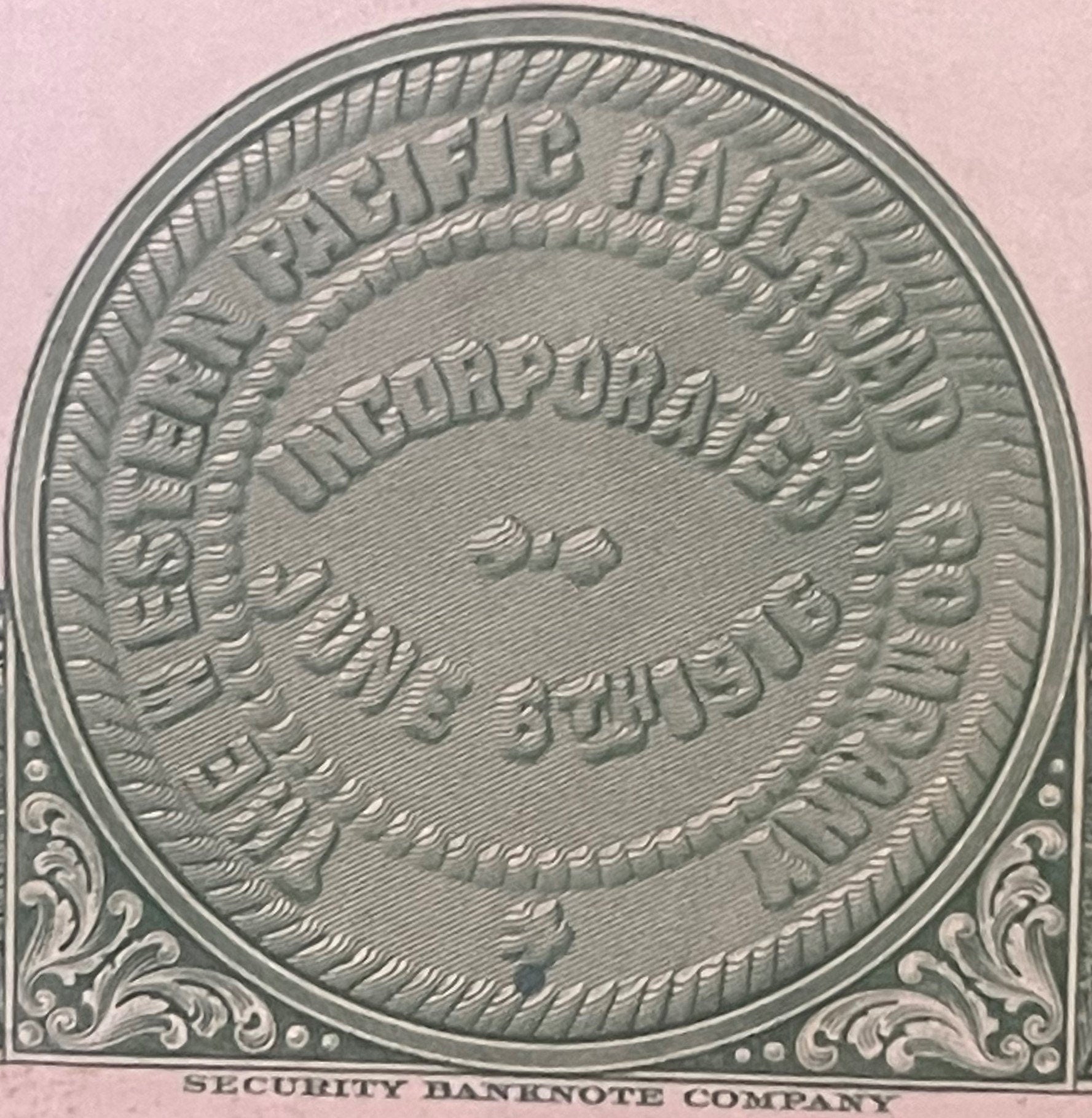 Close-up of ornate circular embossed design from 1945 Western Pacific Railroad bond certificate with decorative border and "S