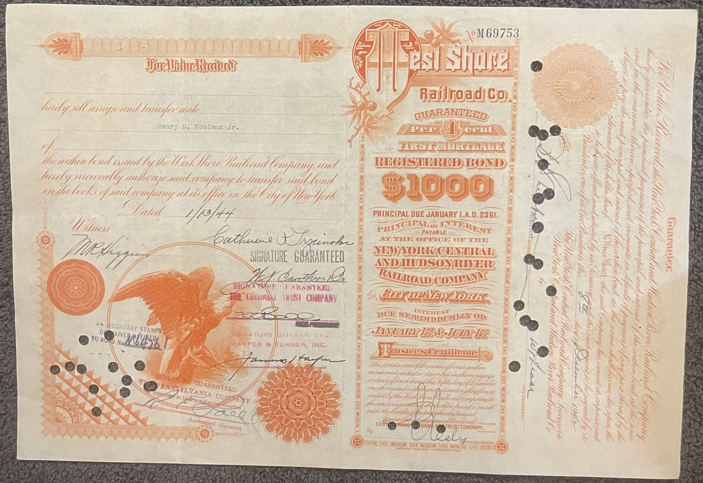 Antique 1942 orange and cream West Shore Railroad $1,000 bond certificate with eagle emblem and multiple signatures, displaye