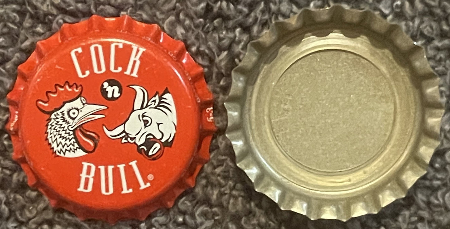 Red and cream bottle cap with rooster and bull graphics, "COCK 'n BULL" text, shown front and back view on textured surface