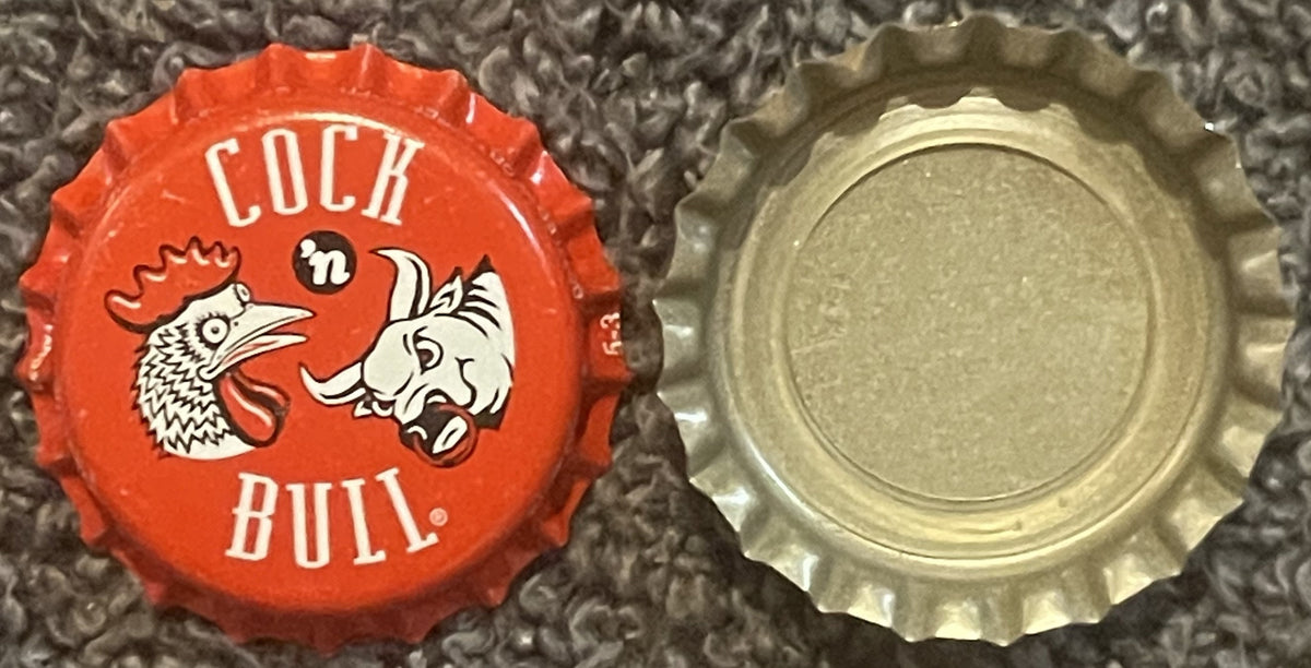 Red and cream bottle cap with rooster and bull graphics, "COCK 'n BULL" text, shown front and back view on textured surface