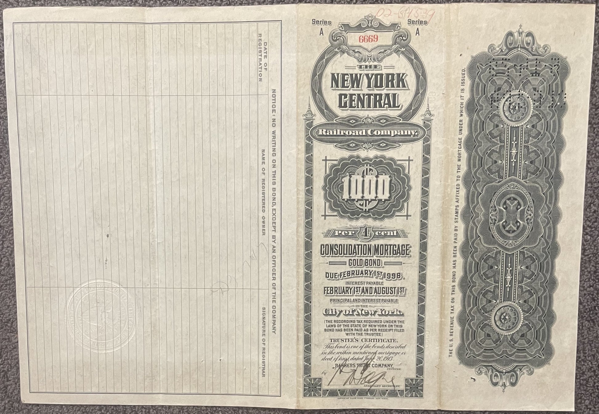 Antique New York Central Railroad gold bond certificate from 1913, showing ornate decorative borders and text on aged cream-c