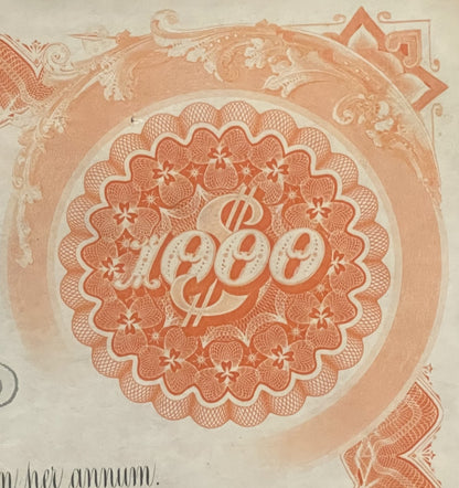 Close-up of ornate orange and cream 1942 West Shore Railroad bond certificate with decorative scalloped medallion featuring "