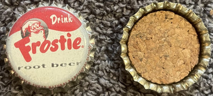 Frostie root beer crown cap: the red and white printed top with the elf and Drink Frostie root beer, beside a cap's cork-lined underside.