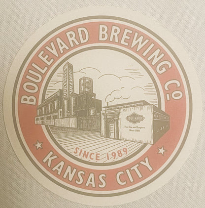 Circular beer coaster with tan and rust-colored design showing Boulevard Brewing Co. Kansas City logo with industrial