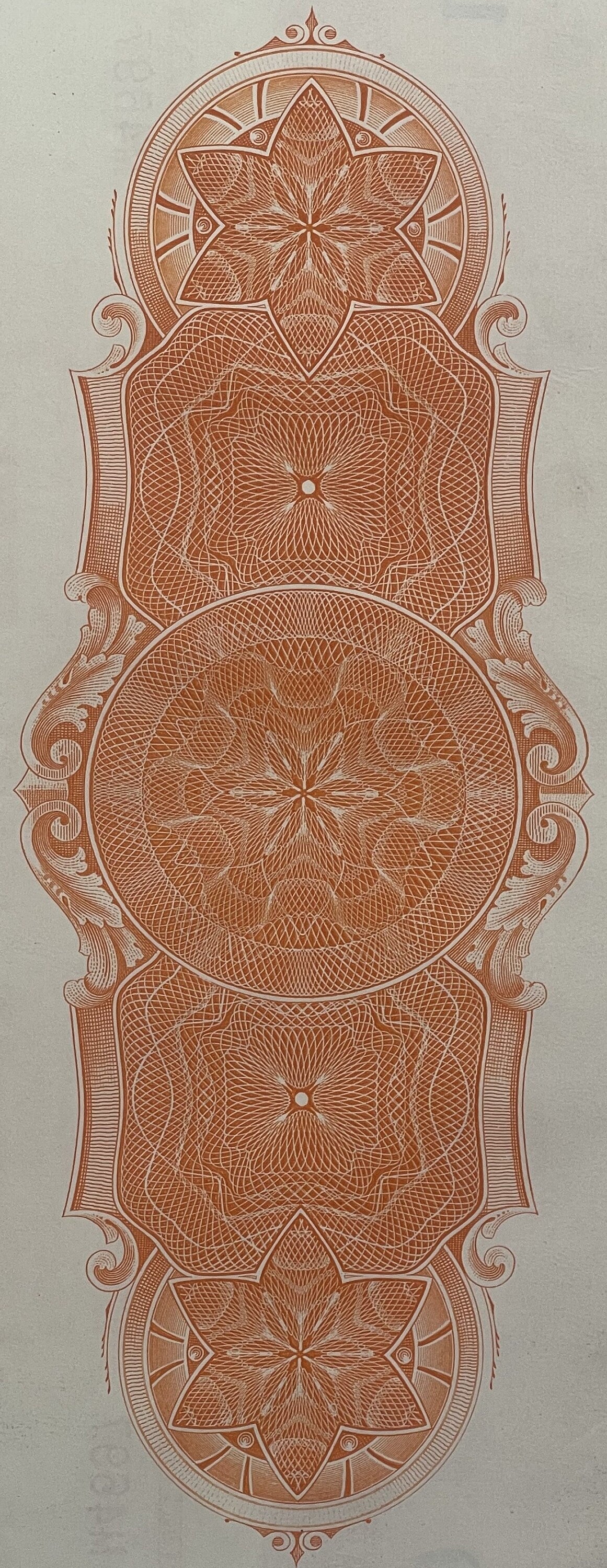 Ornate copper-colored engraved decorative panel with symmetrical floral and geometric patterns, featuring five medallions arr