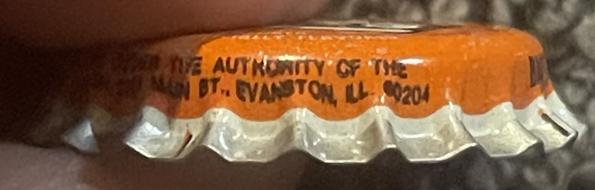 Orange and white cork bottle cap with embossed text reading "Authority of the" and partial address, shown in close-up detail 