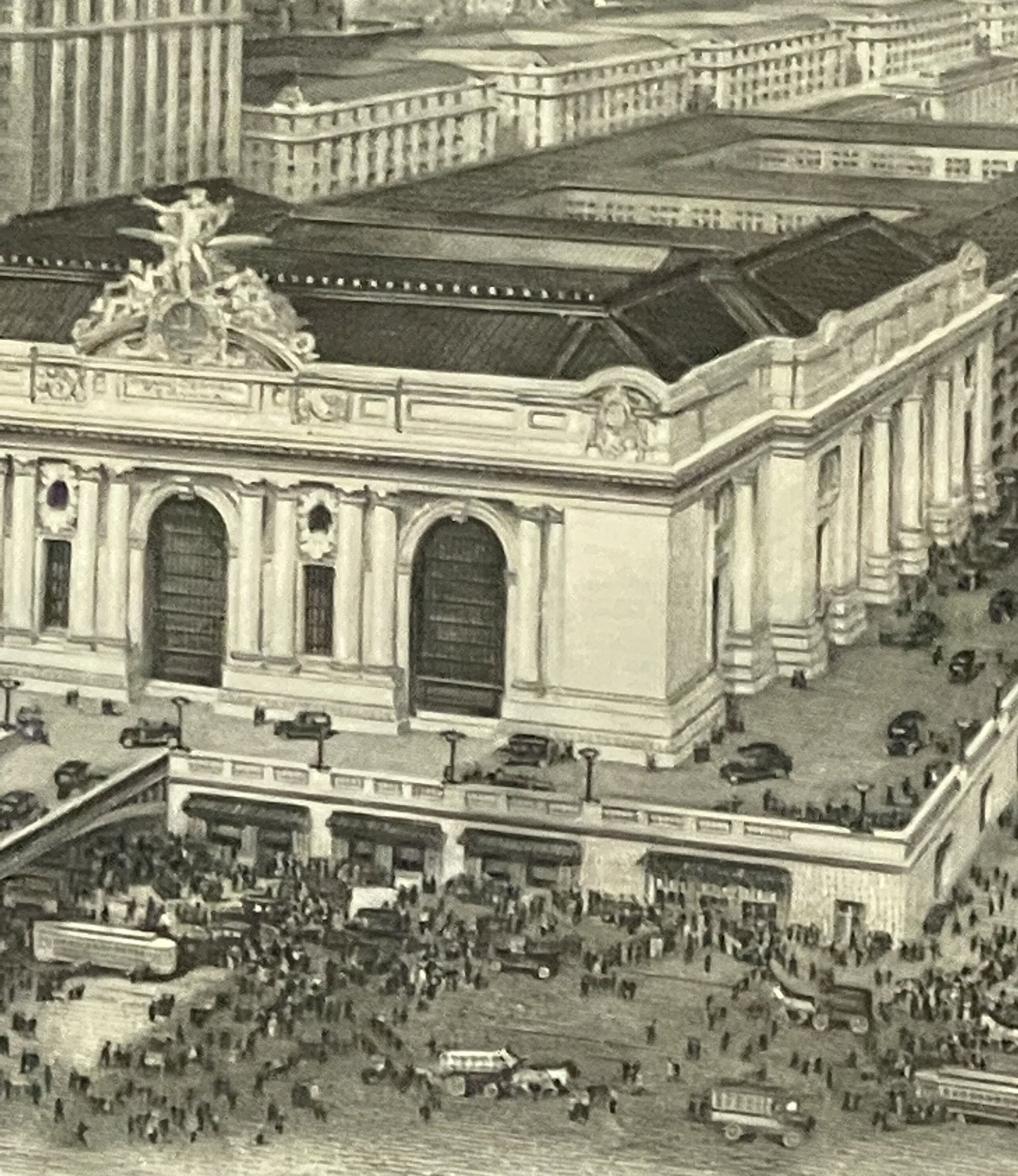 Aerial photograph of Grand Central Terminal in New York City showing the building's facade, roof ornament, and surrounding st
