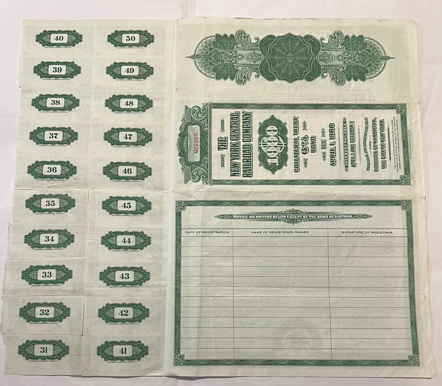 Vintage 1955 New York Central Railroad bond certificate with numbered coupons 31-50 and registration table, printed in green 