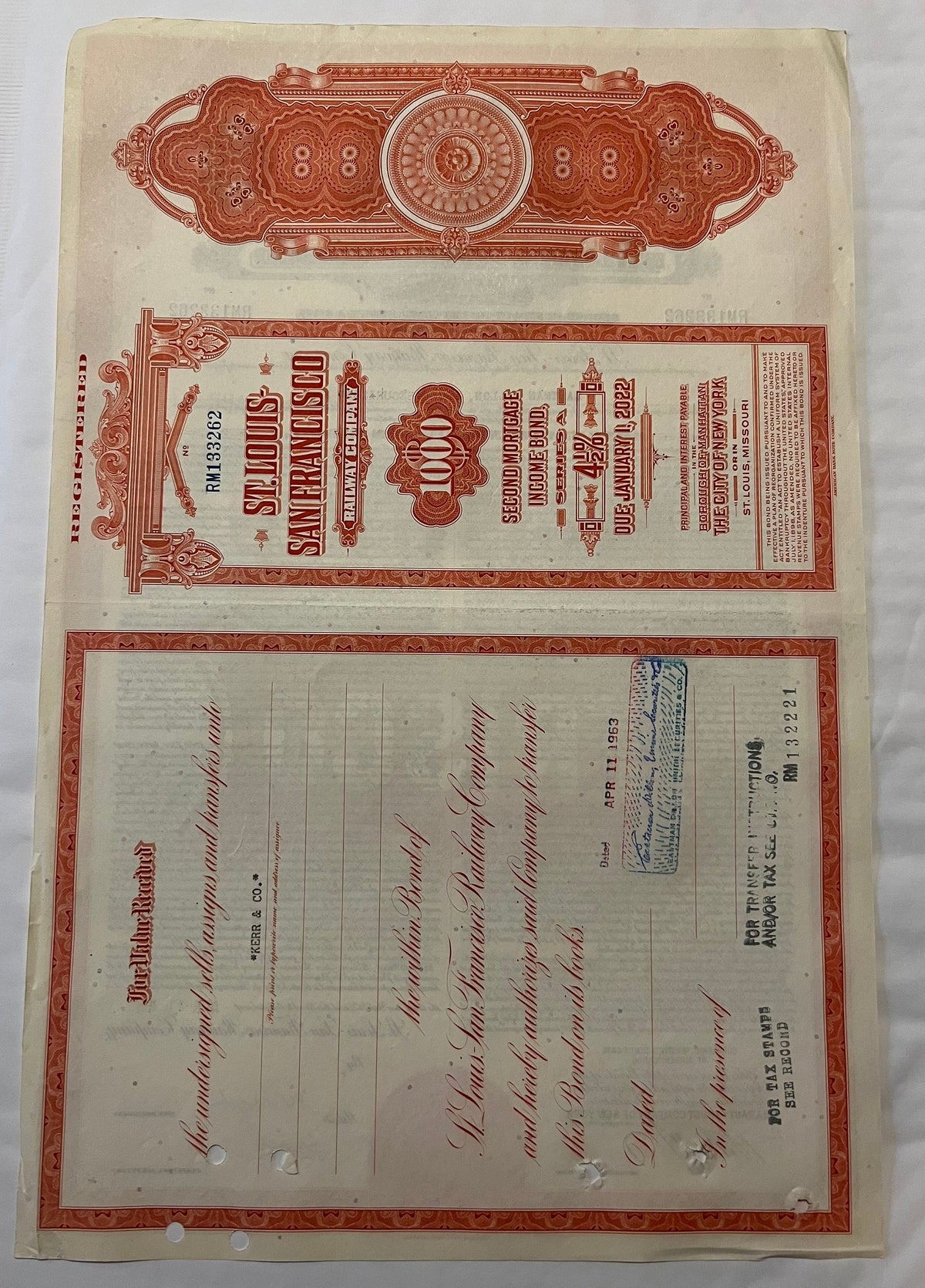 Vintage Frisco Railroad $1,000 gold bond certificate from 1963 with red ornamental borders and decorative emblems, displayed 