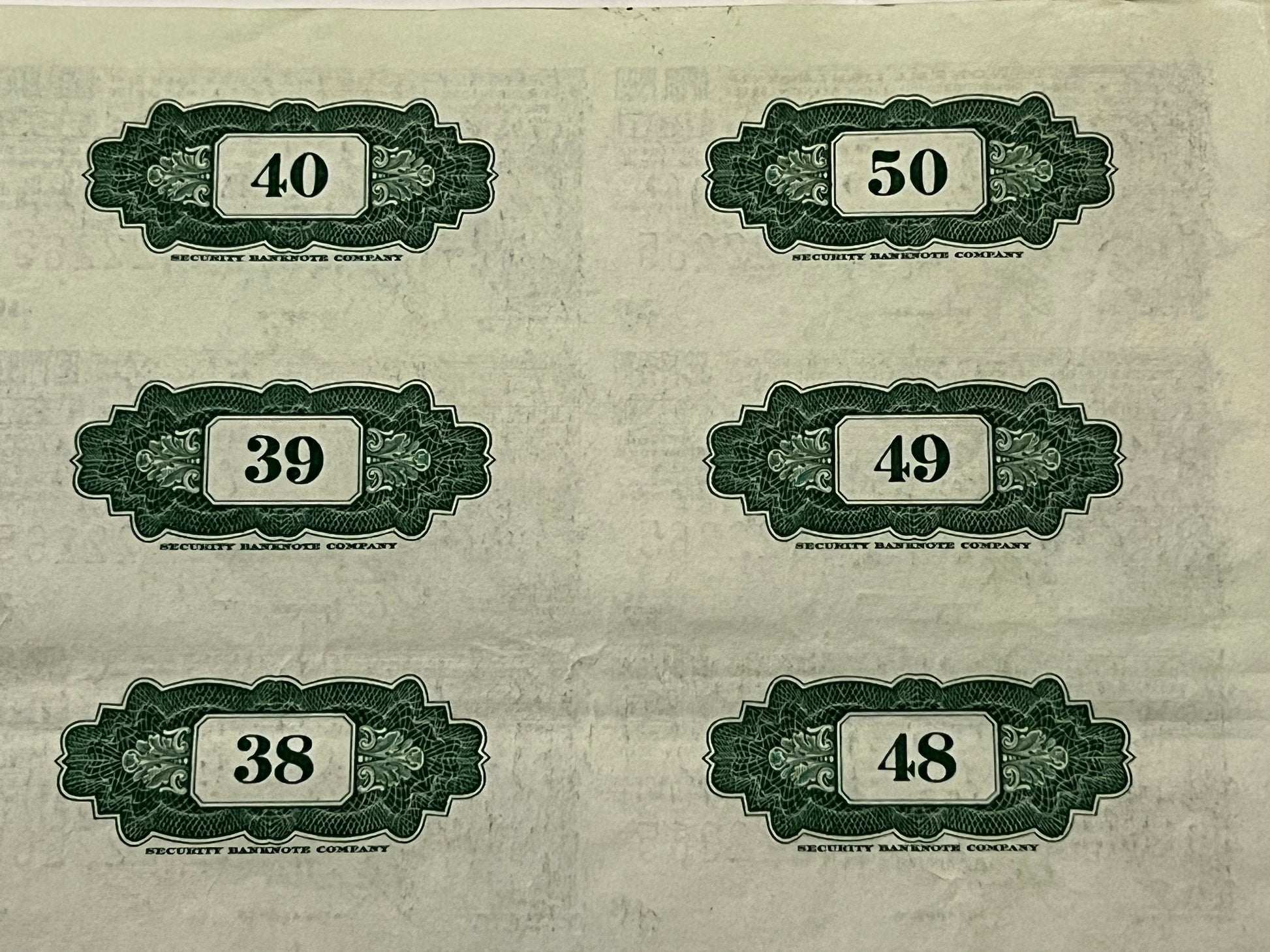 Six vintage security banknote company coupons numbered 38-50 printed in green and black on cream paper