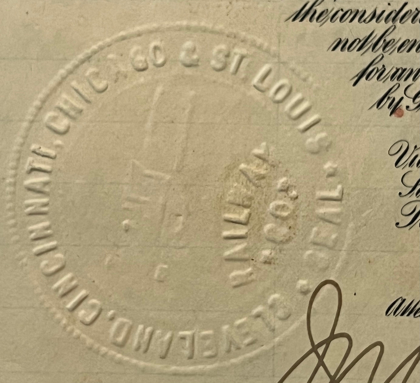 Close-up of embossed circular seal on cream-colored 1927 railroad bond document reading "Big Four St Louis Railway" with hand