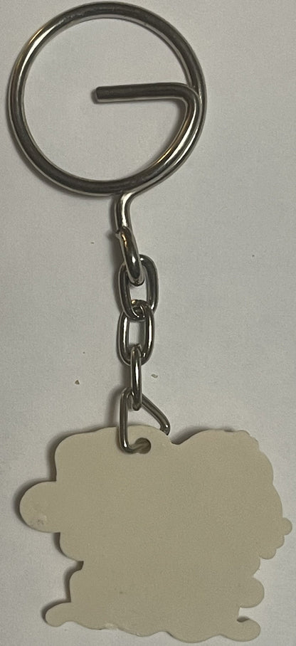 Cream-colored Hello Kitty keychain with scalloped edges hanging from metal split ring and chain against white background